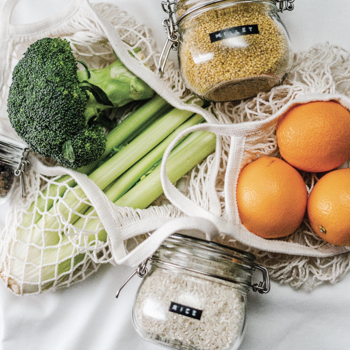 Sustainably packaged food. Bulk ingredients in glass jars, and produce in woven natural fibre produce bags.
