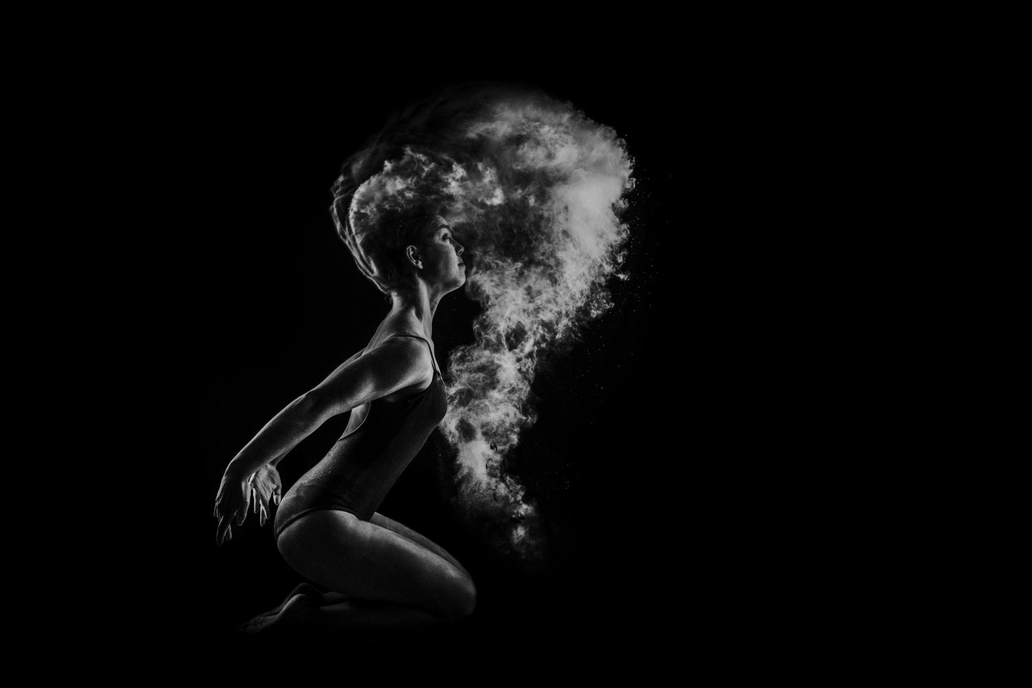 A flexible looking woman performing some form of dance with smoke/steam coming from her body.